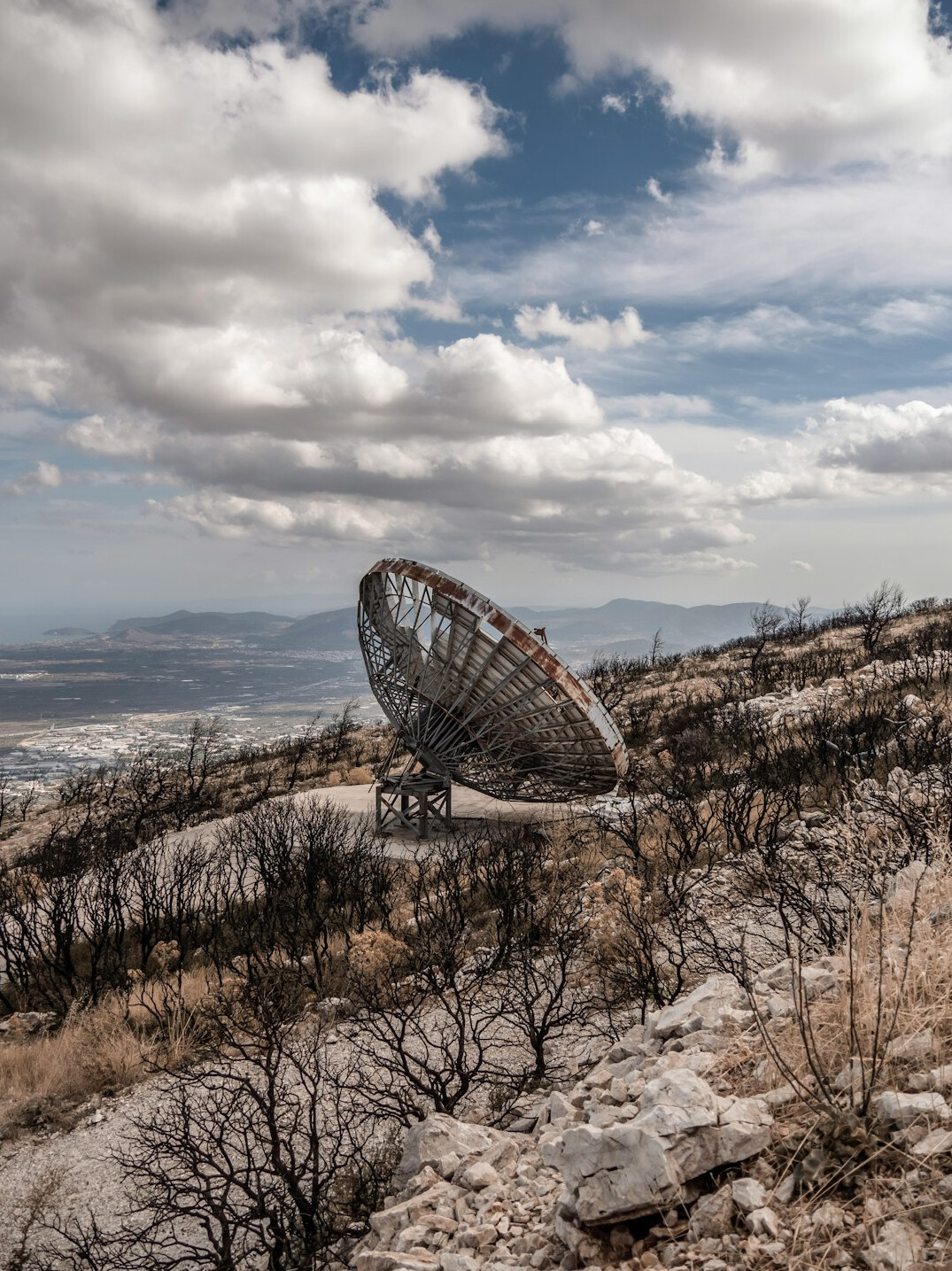Satellite dish pointed at a blue sky at a broadcast uplink site