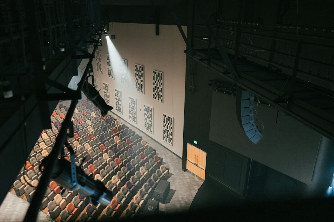 Director's gallery with rows of monitors and mixing desks during a live show