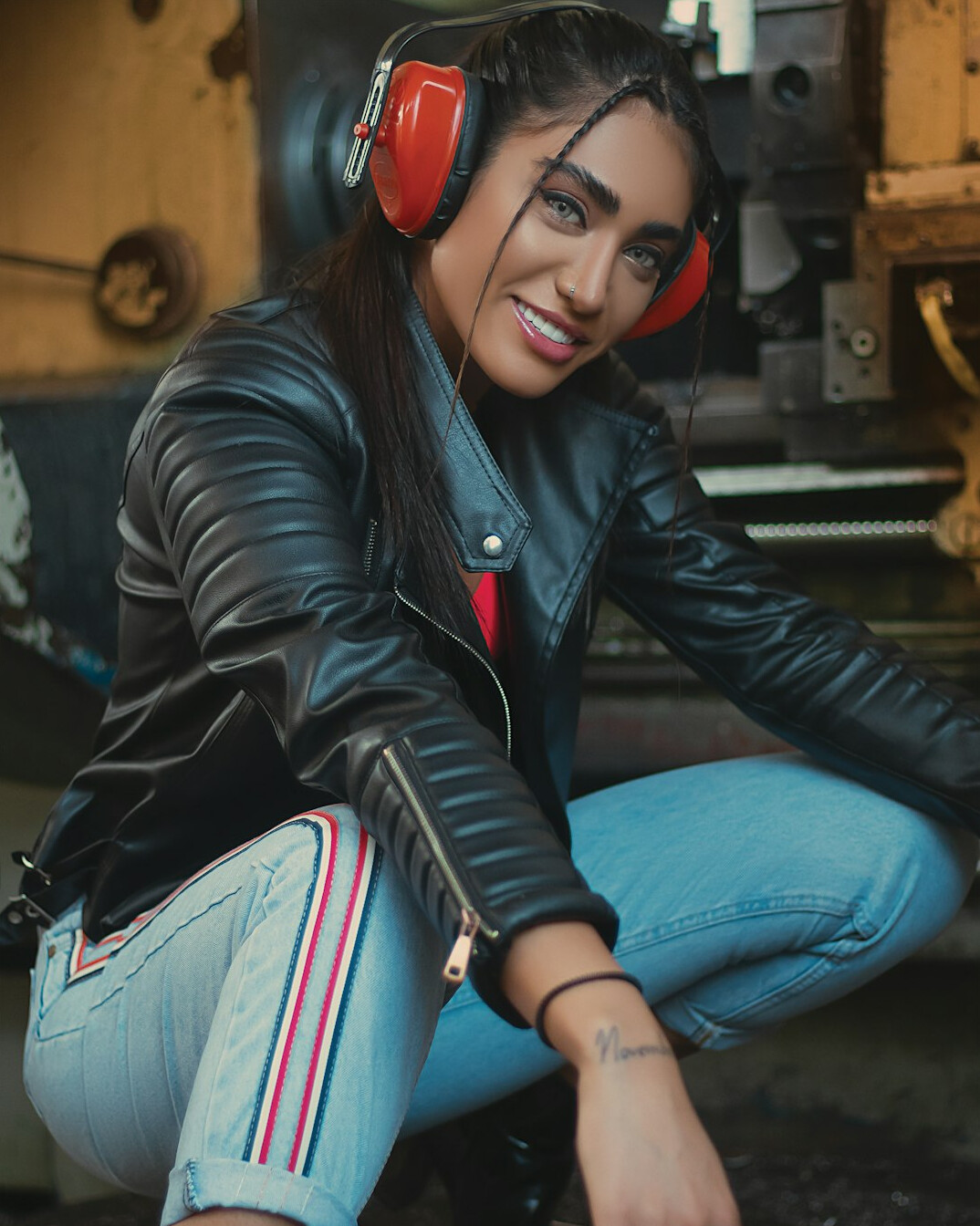 Smiling woman broadcast signal engineer wearing a headset in a control room
