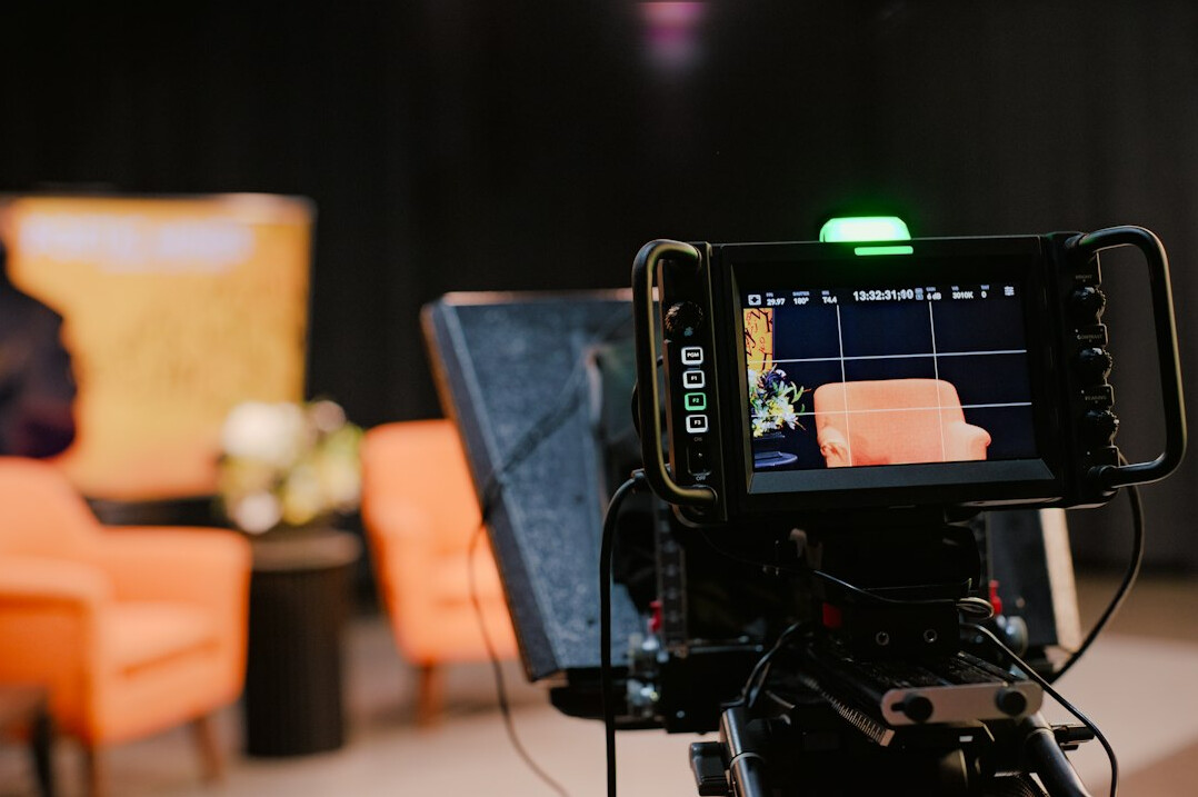Modern television news studio set with desk and backdrop screens